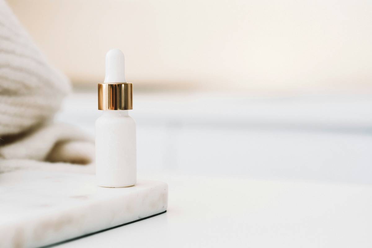 Woman applying organic body lotion benefits visible through smooth, hydrated arms after consistent use